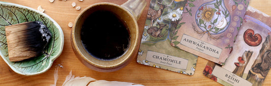 Mug of tea with palo santo and herbal astrology oracle cards